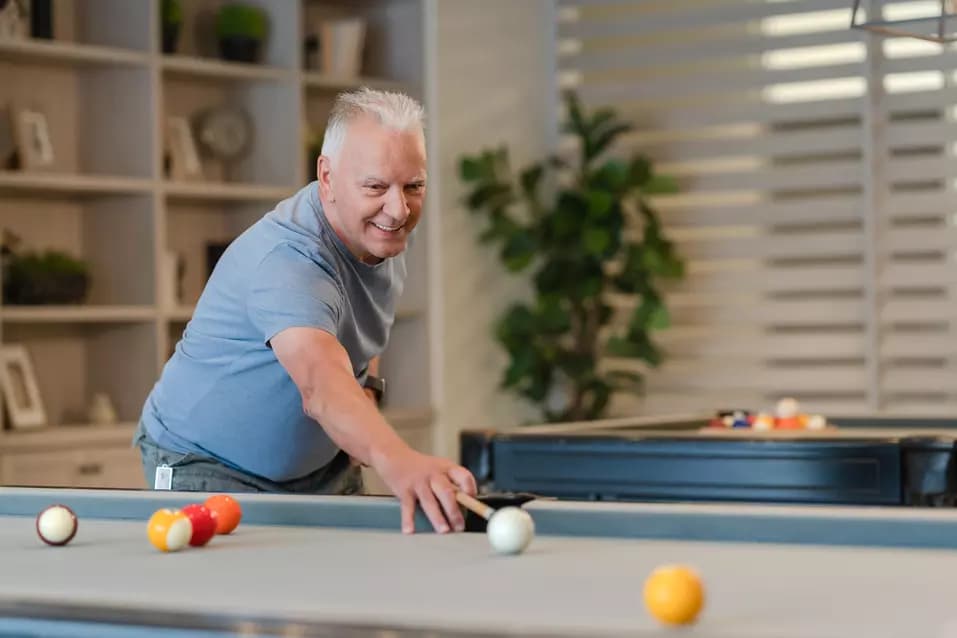 Senior man playing pool