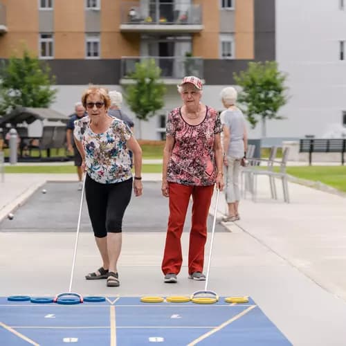 Chartwell senior residents playing outdoor shuffle board