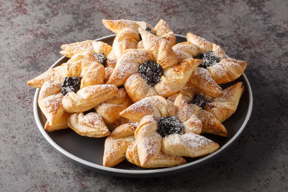 Joulutorttu: traditional Finnish jam tarts made and eaten at Christmas close-up in a plate on a table.