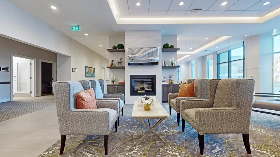 Lounge with chairs and table at Chartwell St. Catharines