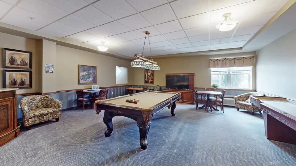 Activity room with pool table at Chartwell Royal Oak Village