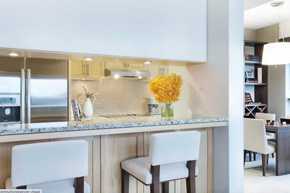 Amenity space with countertop and chairs at Chartwell Wesbrook Village