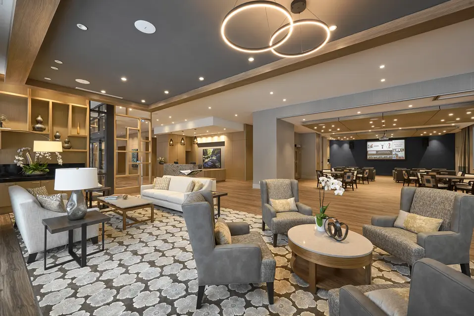 Chartwell Victoria Harbour's common area with sofas, comfortable chairs and view of the dining area.