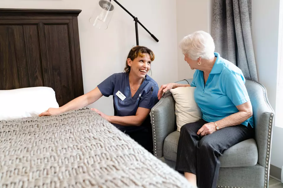 Chartwell Housekeeping Lady making bed and chatting with the Chartwell Senior residence