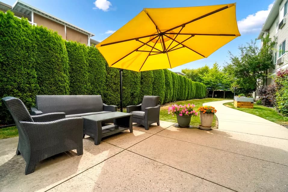 Chartwell Carrington Place's exterior patio and umbrella