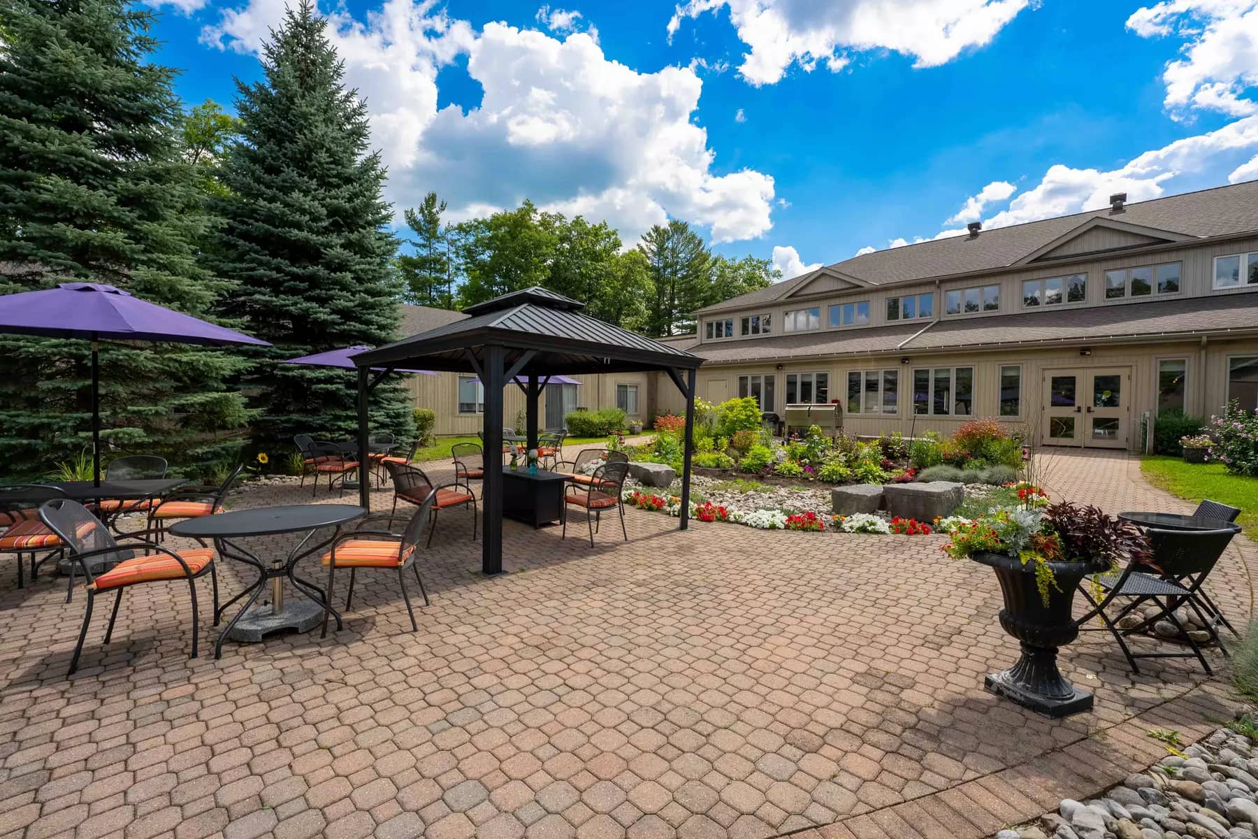 Patio and walking paths at Chartwell Whispering Pines Retirement Residence.