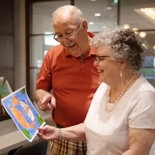 Senior couple admiring the painting they created.