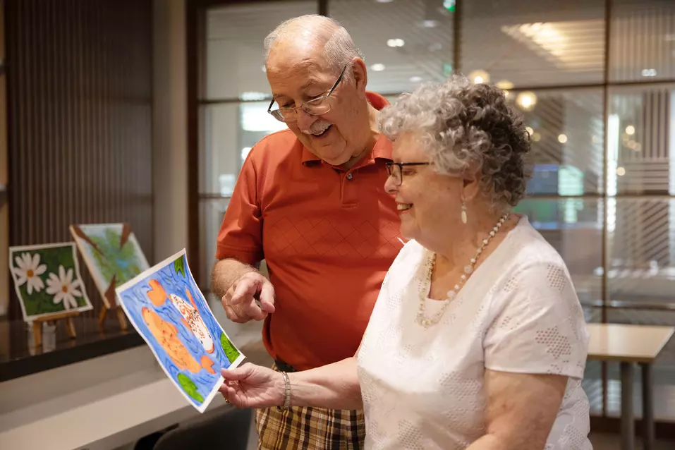 Senior couple admiring the painting they created.