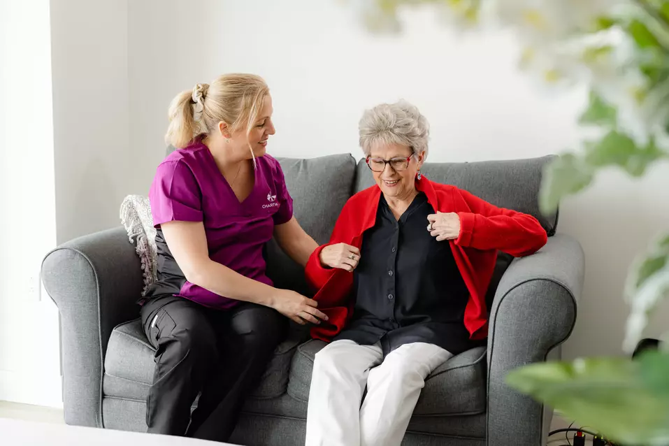 Nurse assisting Senior Chartwell residence dressing