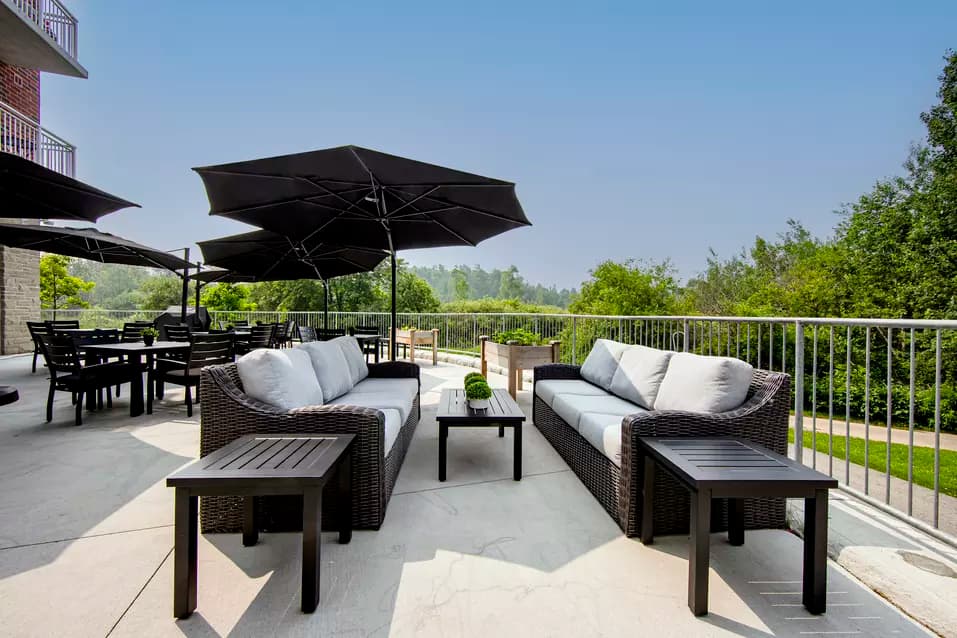 chartwell montgomery village, exterior, patio, outdoor patio, umbrellas, patio set, sofa, chairs, trees