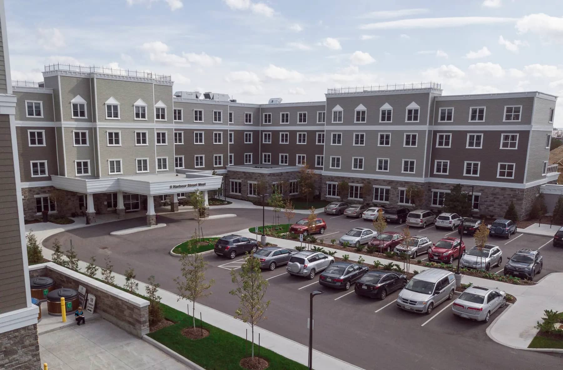 Exterior and parking lot at Chartwell Balmoral Retirement Community.