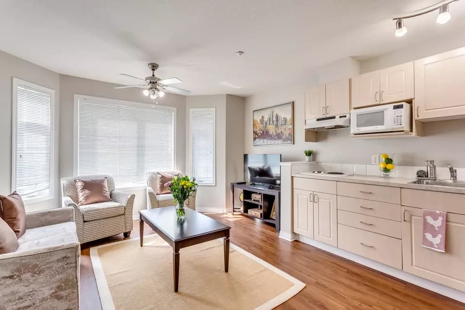 model suite kitchen and living area at chartwell colonel belcher retirement residence