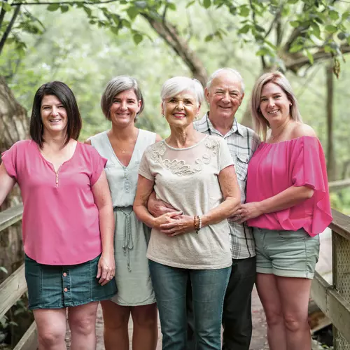 Senior couple with their three daughters on a bridge. Couple de seniors avec leurs trois filles sur un pont