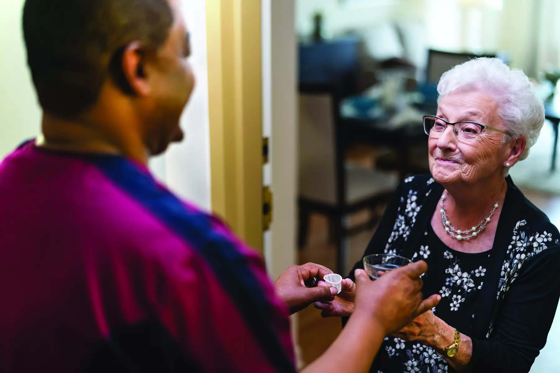 Chartwell Care staff giving medication to the senior resident.