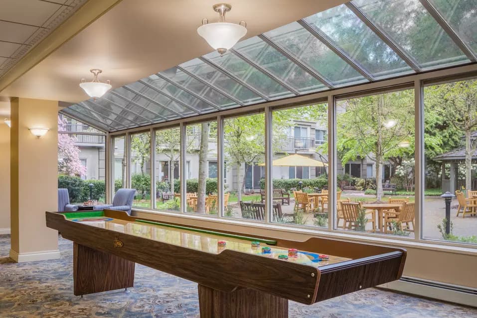 sunny shuffleboard table at chartwell langley gardens assisted living