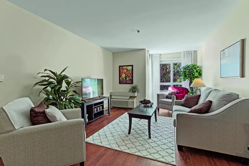 A illuminated spacious living room suite of Chartwell Isabella Retirement Residence