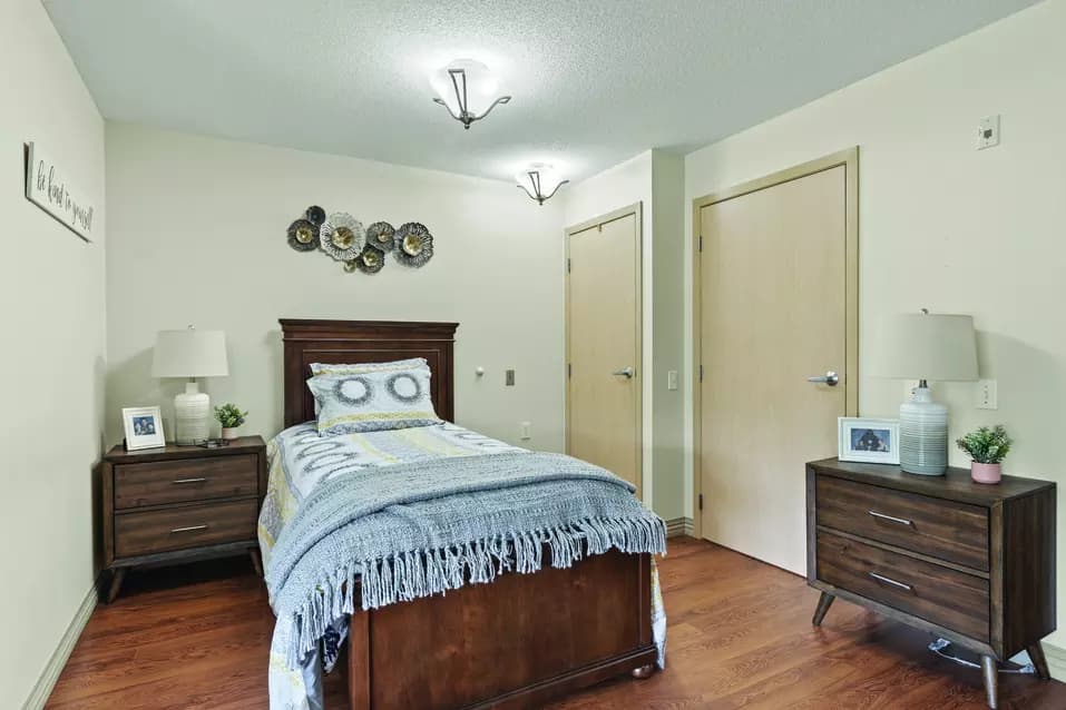 A cozy bedroom of Chartwell Glacier Ridge Retirement Residence