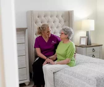 Chartwell Care staff chatting with the senior resident