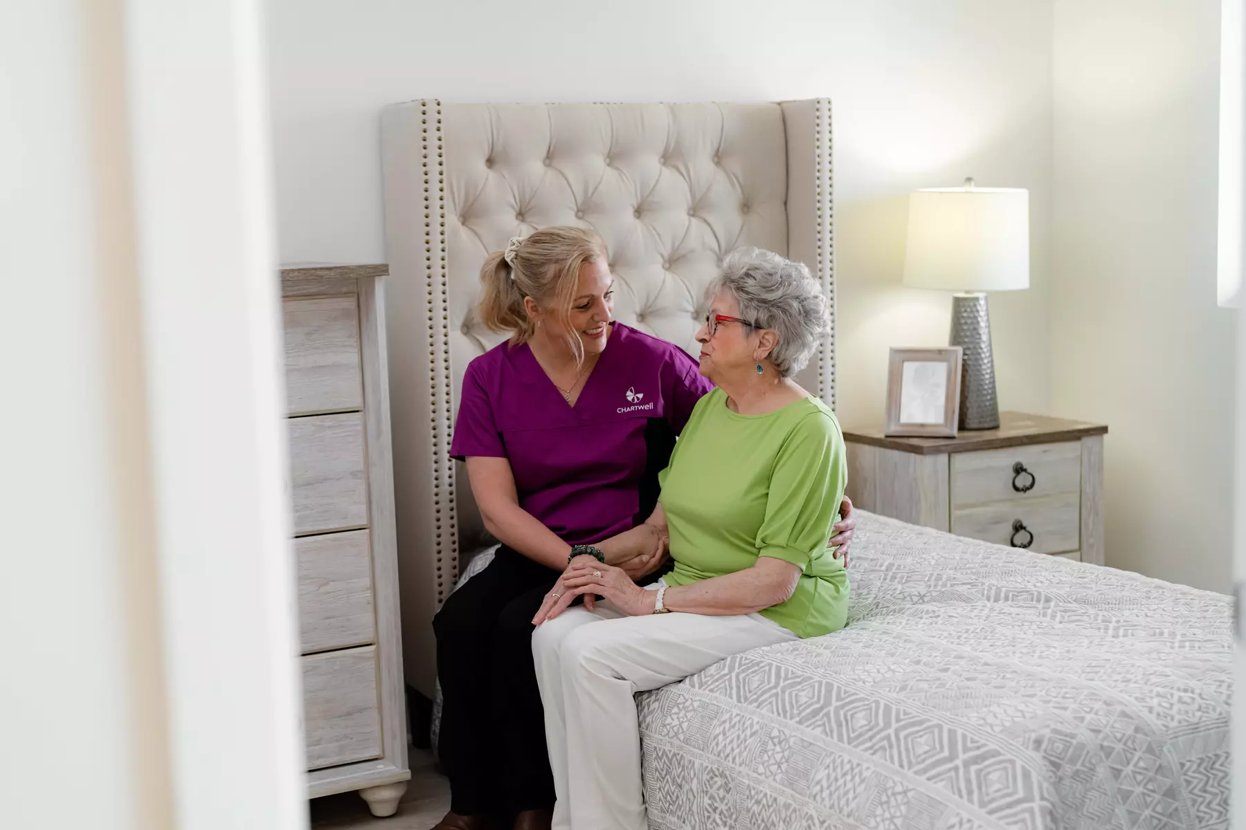 Chartwell Care staff chatting with the senior resident