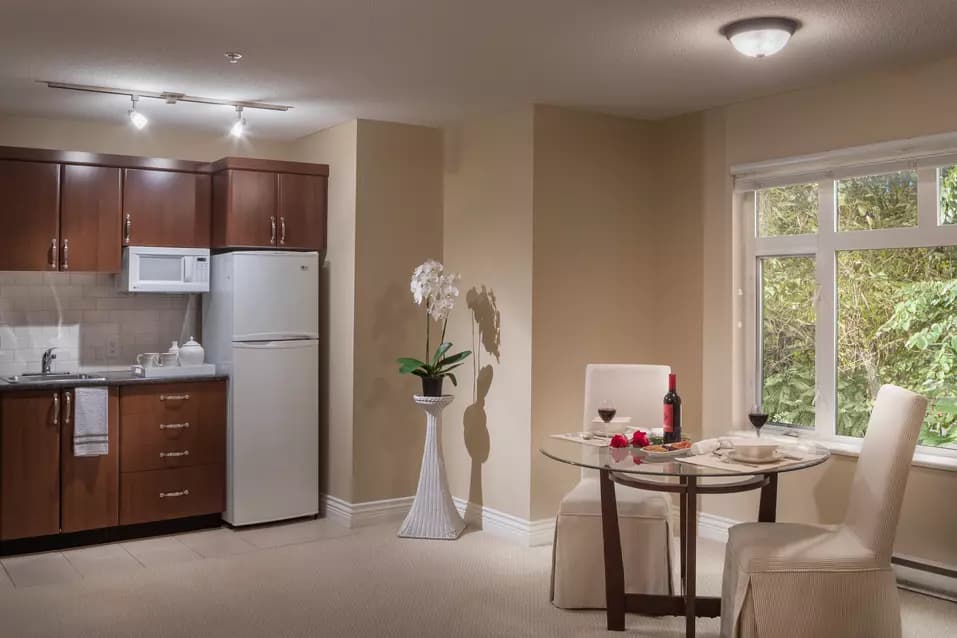model suite dining room and kitchen at chartwell churchill house retirement residence
