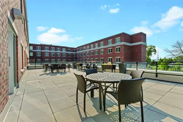 Chartwell Allandale Station Retirement Residence second floor terrace with patio furniture.