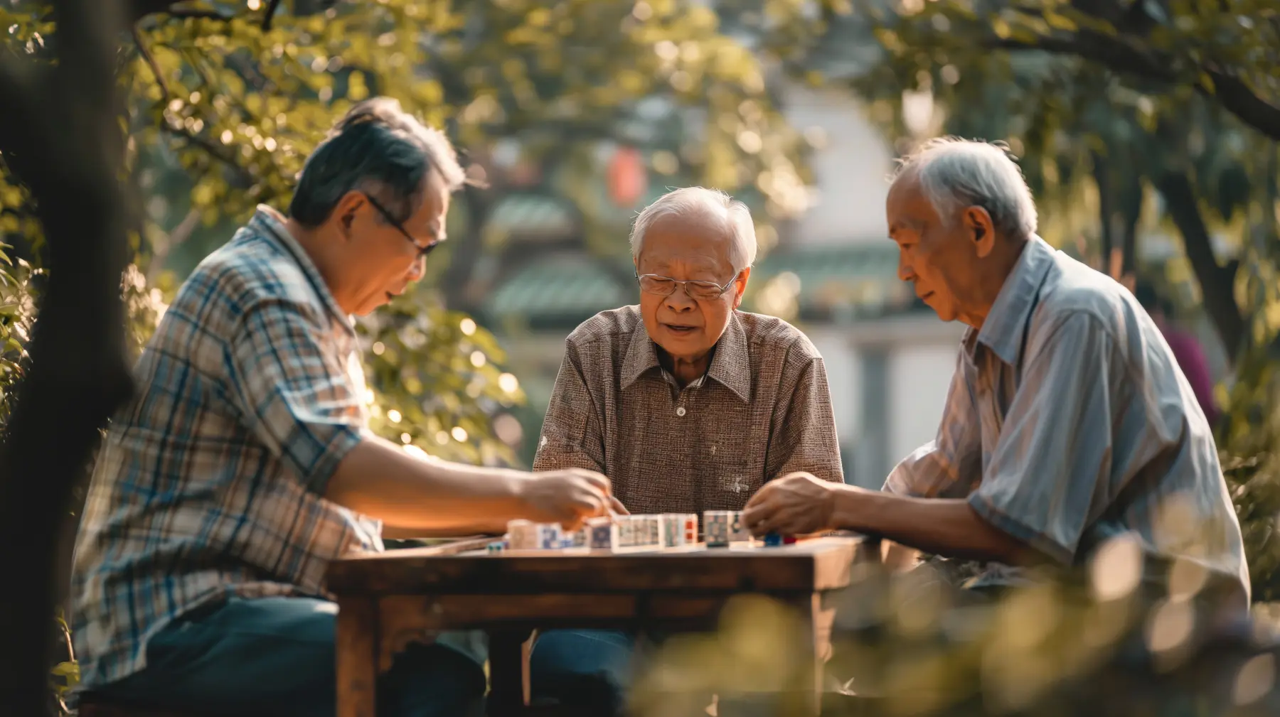 Senior Chinese men playing Mahjong outdoors
