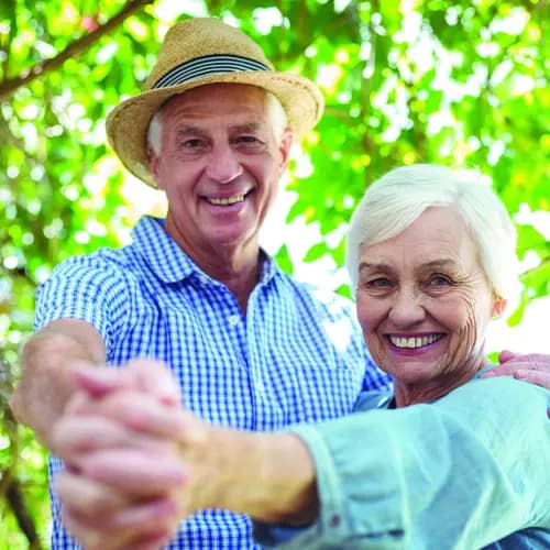 Senior couple dancing together outside. Couple de seniors dansant ensemble à l'extérieur