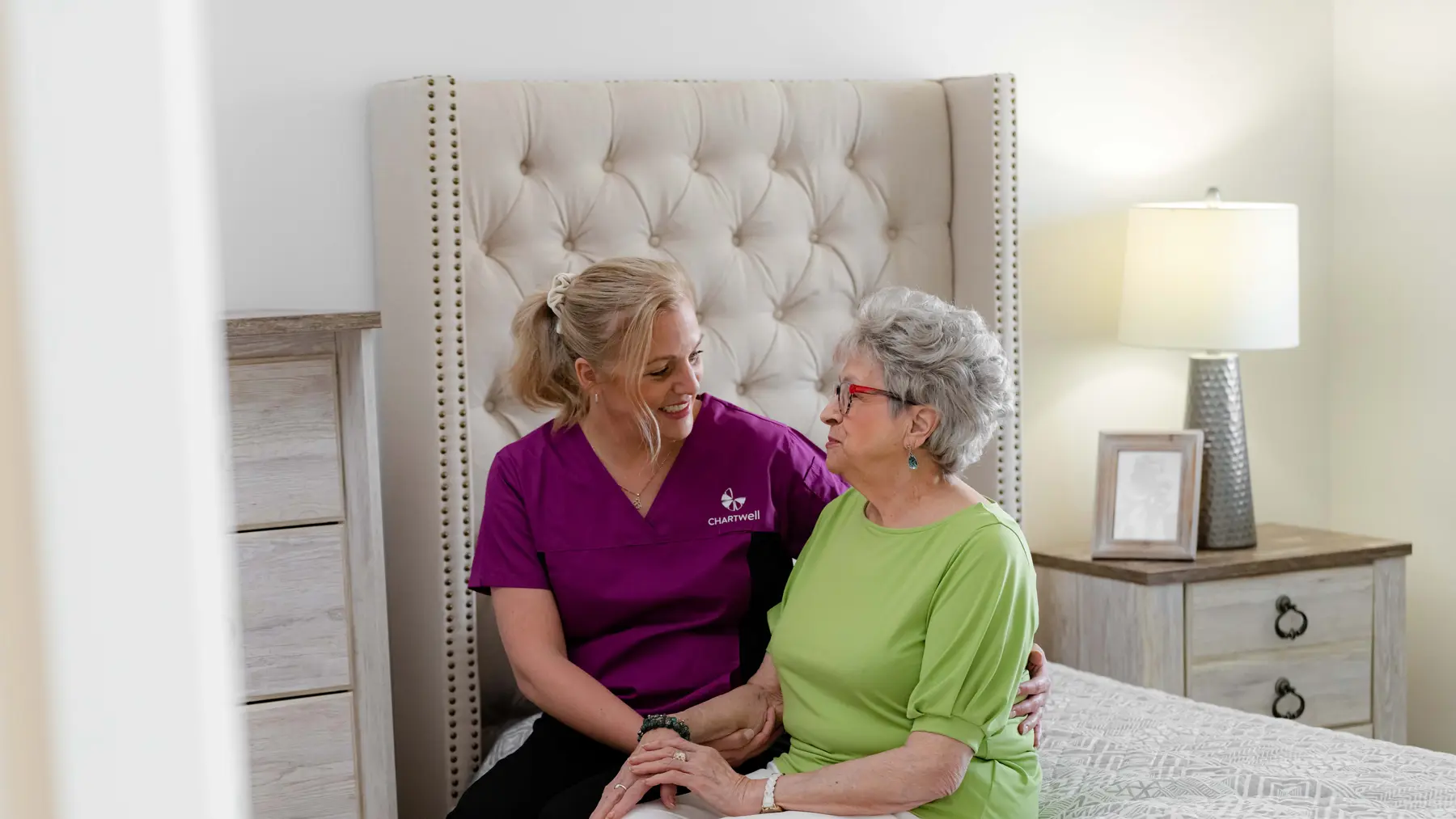 Chartwell Care staff chatting with the senior resident