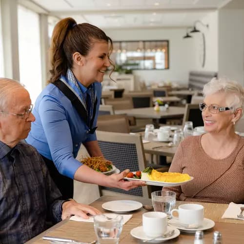 Chartwell server serving omelette to the senior resident