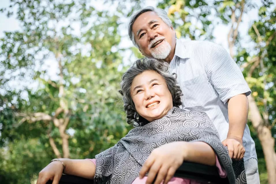 Senior man cares for wife in wheelchair