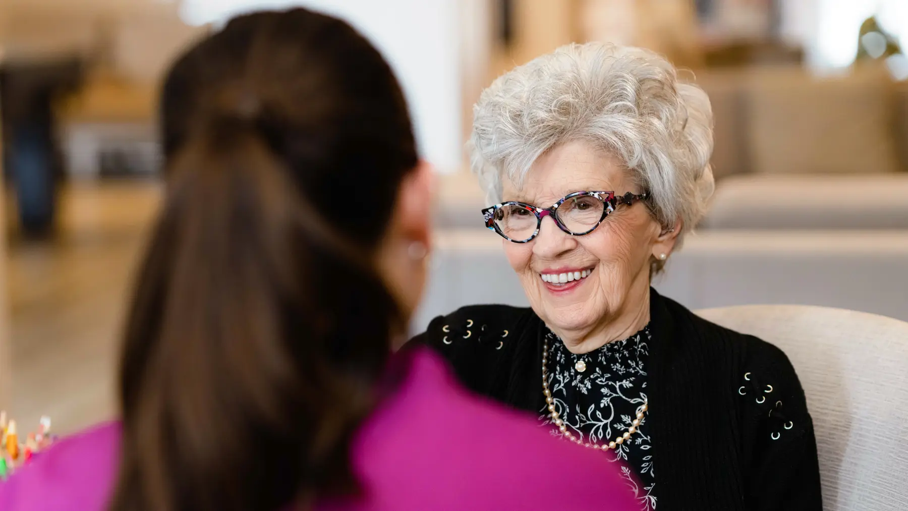Chartwell staff chatting with the senior resident