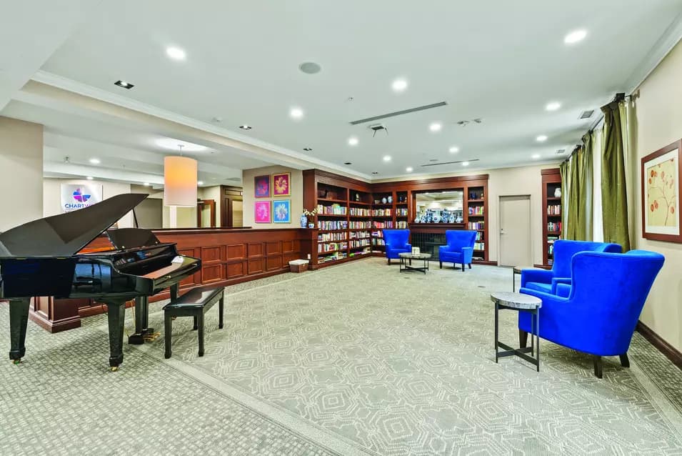 Open and bright library at Chartwell Hollandview Trail Retirement Residence.