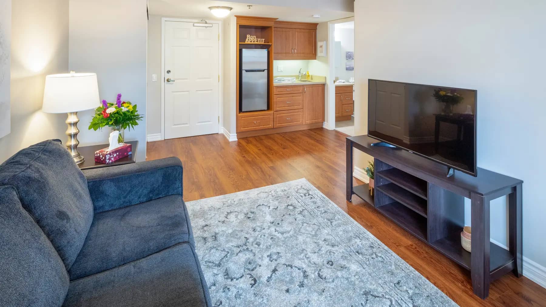 Chartwell Martha's Landing Retirement Residence suite living room with kitchenette